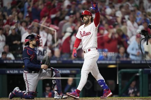 Philadelphia Phillies' Bryce Harper reacts after hitting a home run during the fifth inning of Game 3 of a baseball NL Division Series against the Atlanta Braves Wednesday, Oct. 11, 2023, in Philadelphia. (AP Photo/Matt Slocum)