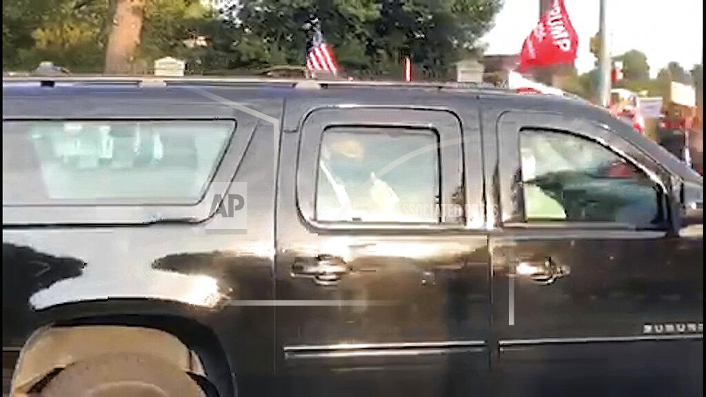 Phillip Crowther In this image from video, President Donald Trump drives past supporters gathered outside Walter Reed National Military Medical Center in Bethesda, Md., Sunday, Oct. 4, 2020. Trump was admitted to the hospital after contracting COVID-19. (AP Photo/Phillip Crowther)