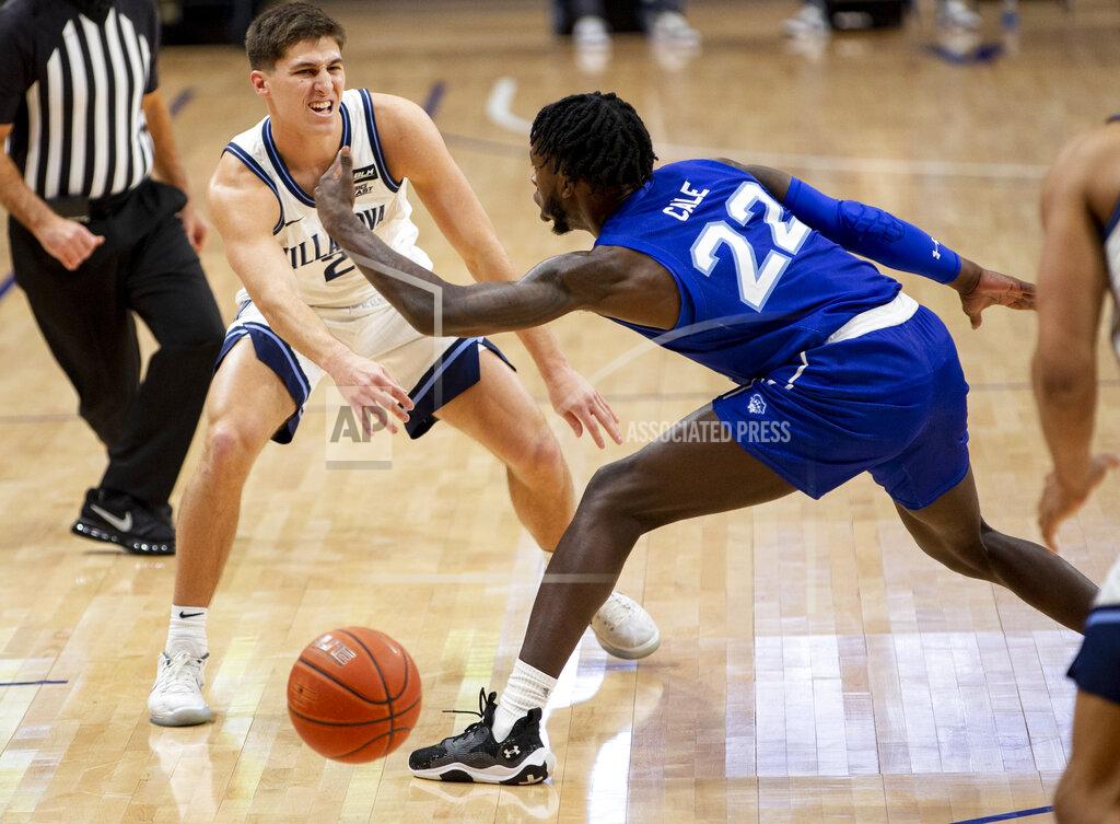 Laurence Kesterson Villanova guard Collin Gillespie (2) passes the ball past Seton Hall guard Myles Cale (22) during the first half of an NCAA college basketball game, Tuesday, Jan. 19, 2021, in Villanova, Pa. (AP Photo/Laurence Kesterson)