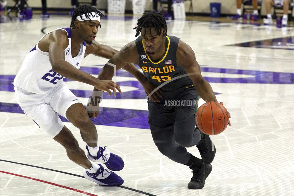 Richard W. Rodriguez File-TCU guard RJ Nembhard (22) defends as Baylor guard Davion Mitchell (45) drives the ball past during a men's NCAA college basketball game, Saturday, Jan. 9, 2021. Mitchell and MaCio Teague, two of the league’s best shooters, were part of a Big 12-record 23-game winning streak last season in their debuts as Baylor starters. Those former transfers had also gone through a redshirt season together. (AP Photo/ Richard W. Rodriguez, File)