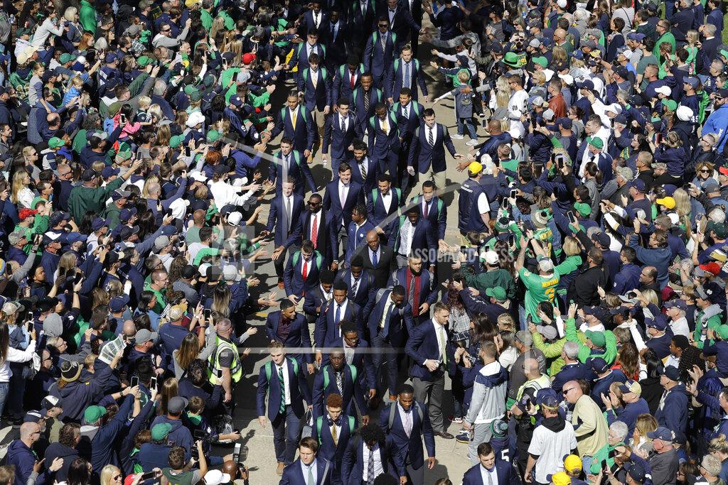 Darron Cummings FILE - In this Oct. 5, 2019, file photo, Notre Dame players greet fans as they enter the stadium before an NCAA college football game against Bowling Green, in South Bend, Ind. College football fans will head back into stadiums this weekend. Along with binoculars, sunscreen and other essentials, some will pack facemasks and proof of vaccination. With the availability of COVID-19 vaccines, the pomp and pageantry of fall Saturdays are expected to return nearly everywhere across the country. (AP Photo/Darron Cummings, File)