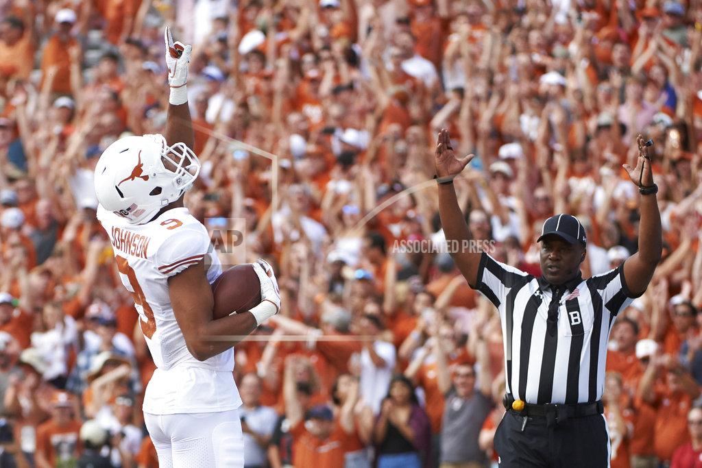 Cooper Neill FILE- In this Saturday, Oct. 6, 2018, file photo, Texas wide receiver Collin Johnson (9) celebrates after scoring a touchdown on a 2-yard reception during the first half of an NCAA college football game against Oklahoma at the Cotton Bowl in Dallas. Johnson and Lil’Jordan Humphrey have been a big problem for opposing defenses. The duo has combined for 65 catches and eight touchdowns for the No. 9 Longhorns. (AP Photo/Cooper Neill, File)