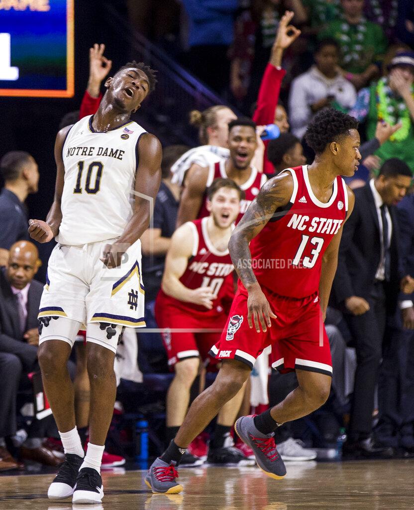 Robert Franklin Notre Dame's T.J. Gibbs Jr. (10) reacts after North Carolina State's C.J. Bryce (13) made a 3-pointer during the second half of an NCAA college basketball game Saturday, Jan. 19, 2019, in South Bend, Ind. North Carolina State won 77-73. (AP Photo/Robert Franklin)