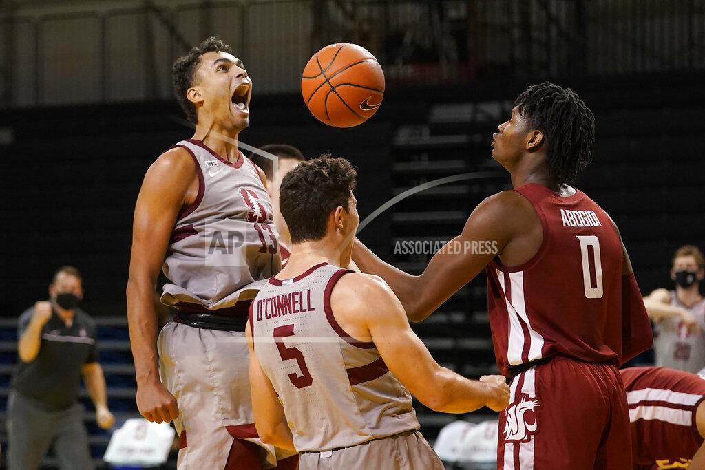Jeff Chiu Stanford forward Oscar da Silva, left, celebrates after scoring and being fouled with teammate Michael O'Connell (5) in front of Washington State center Efe Abogidi (0) during the second half of an NCAA college basketball game in Santa Cruz, Calif., Saturday, Jan. 9, 2021. (AP Photo/Jeff Chiu)