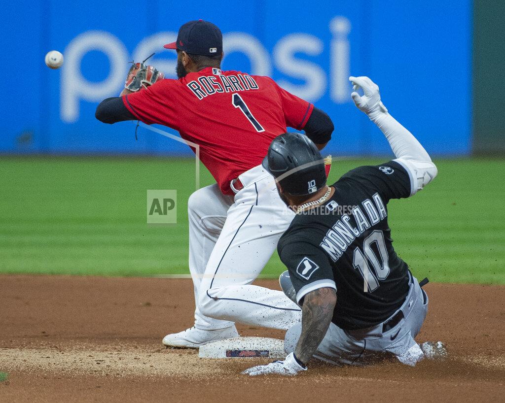 Phil Long Chicago White Sox's Yoan Moncada slides safely into second base with a double as Cleveland Indians' Amed Rosario waits for the throw during the fifth inning of a baseball game in Cleveland, Saturday, Sept. 25, 2021. (AP Photo/Phil Long)