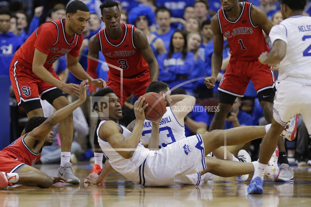 Seth Wenig Seton Hall's Ike Obiagu, bottom, looks to pass during the first half of an NCAA college basketball game against St. John's in Newark, N.J., Sunday, Feb. 23, 2020. (AP Photo/Seth Wenig)
