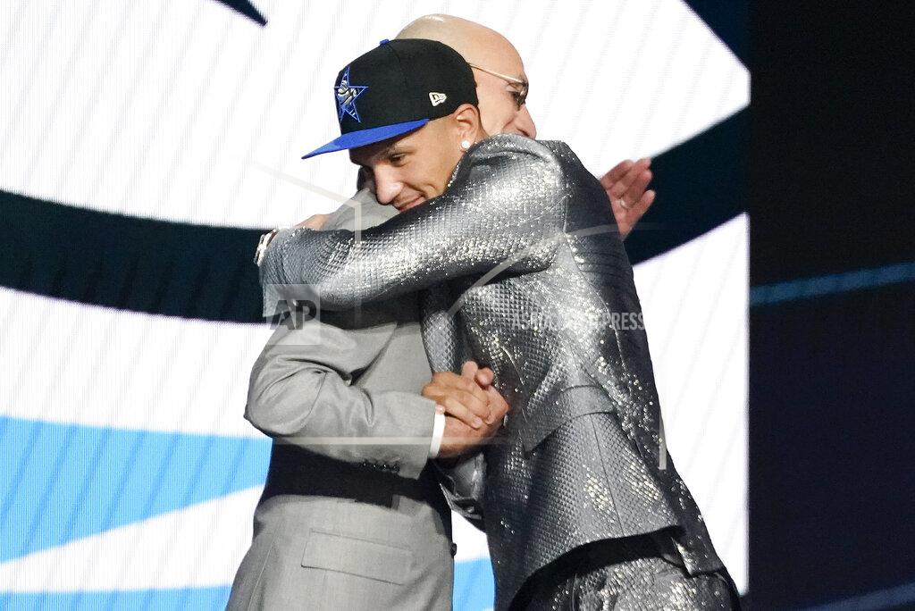 Corey Sipkin Jalen Suggs hugs NBA Commissioner Adam Silver after being selected fifth overall by the Orlando Magic during the NBA basketball draft, Thursday, July 29, 2021, in New York. (AP Photo/Corey Sipkin)
