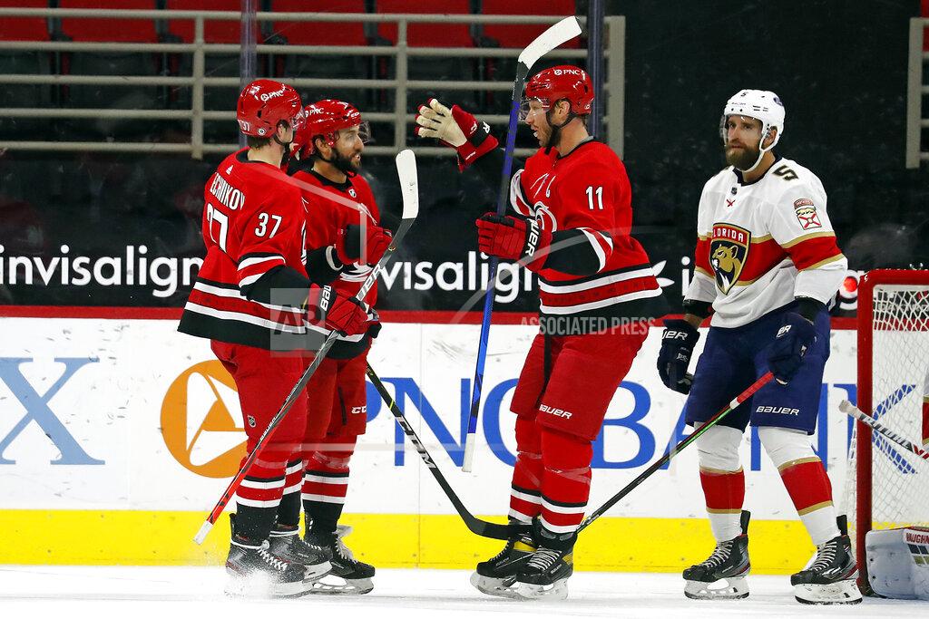 Karl B Deblaker Carolina Hurricanes' Vincent Trocheck (16), center, is congratulated on his goal by teammates Jordan Staal (11) and Andrei Svechnikov (37) with Florida Panthers' Aaron Ekblad (5) nearby during the first period of an NHL hockey game in Raleigh, N.C., Sunday, March 7, 2021. (AP Photo/Karl B DeBlaker)