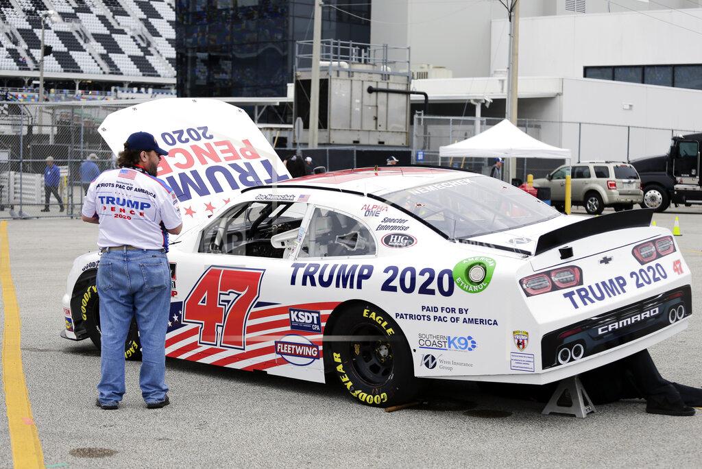 Terry Renna Crew members make adjustments to Joe Nemecheck's car sponsored by Patriots PAC of America during practice for the NASCAR Xfinity Series auto race at Daytona International Speedway, Friday, Feb. 14, 2020, in Daytona Beach, Fla. Trump is scheduled to be present for the Daytona 500 on Sunday and he will find this environment as welcoming as one of his campaign rallies. (AP Photo/Terry Renna)