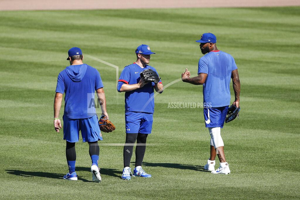 Kamil Krzaczynski Chicago Cubs right fielder Jason Heyward, right, talks with center fielder Ian Happ, center, and left fielder Kyle Schwarber, left, during baseball practice at Wrigley Field on Friday, July 3, 2020 in Chicago. (AP Photo/Kamil Krzaczynski)