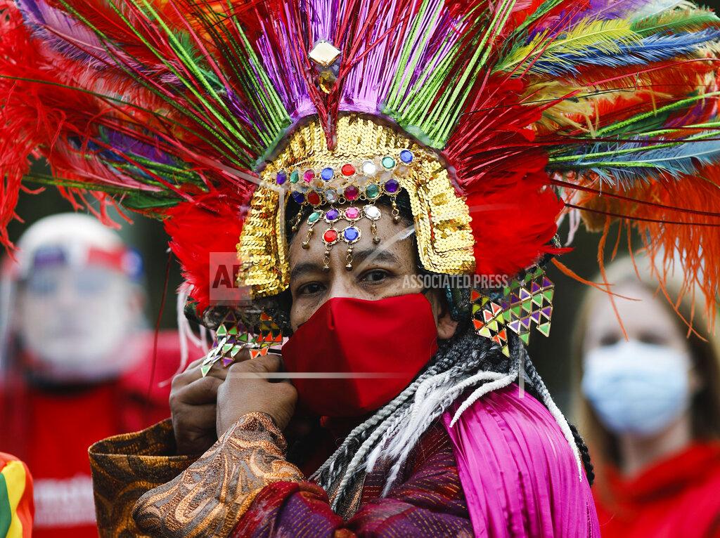 Markus Schreiber A man in a costume adjust his face mask as he attends a protest of people working in the entertainment and event industry against the German government's economic policies to combat the spread of the coronavirus and COVID-19 disease and demand more support for their business, in Berlin, Germany, Wednesday, Oct. 28, 2020. (Photo/Markus Schreiber)