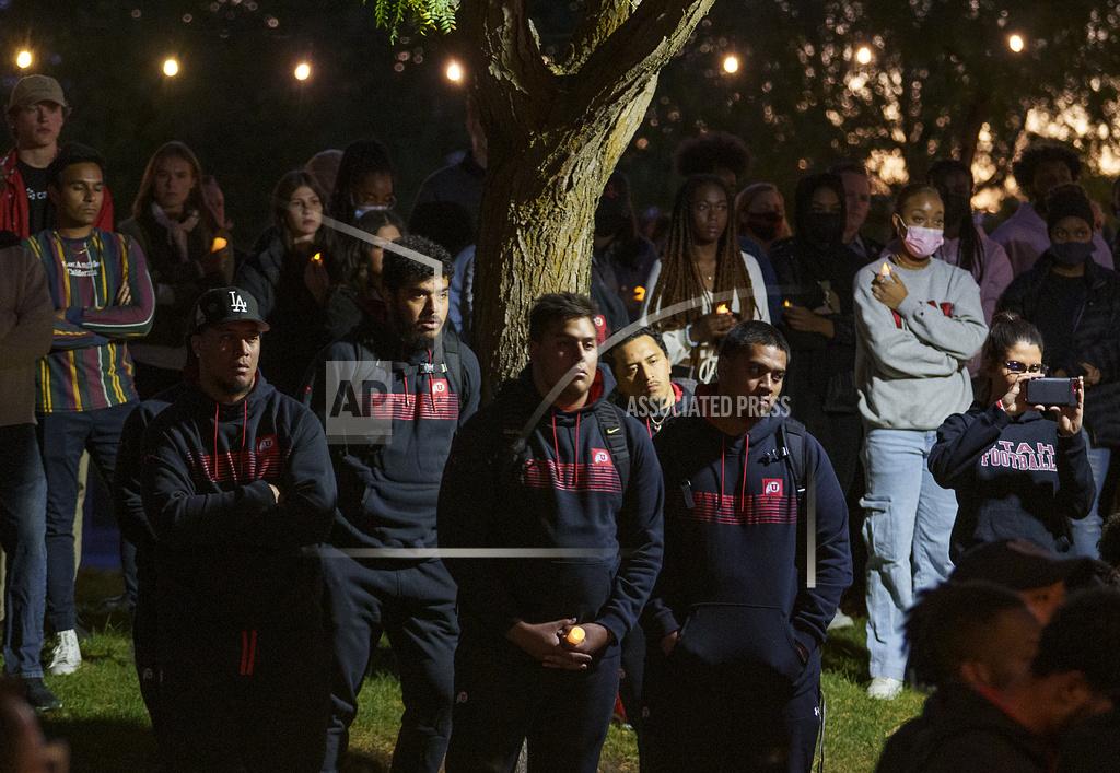 Leah Hogsten Members of the University of Utah football team mourn the loss of fellow student-athlete Aaron Lowe during a candlelight vigil on the southwest lawn of the university's student union, Wednesday, Sept. 29, 2021, in Salt Lake City. Lowe was fatally shot at a house party early Sunday, Sept. 26. (Leah Hogsten/The Salt Lake Tribune via AP)