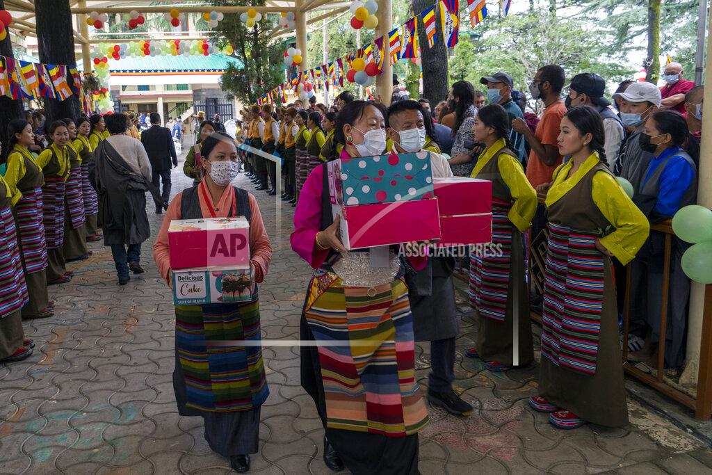 Ashwini Bhatia Exile Tibetans in traditional attire carry cakes to mark the 87th birthday of Tibetan spiritual leader the Dalai Lama at the Tsuglakhang temple in Dharmsala, India, Wednesday, July 6, 2022. (AP Photo/Ashwini Bhatia)