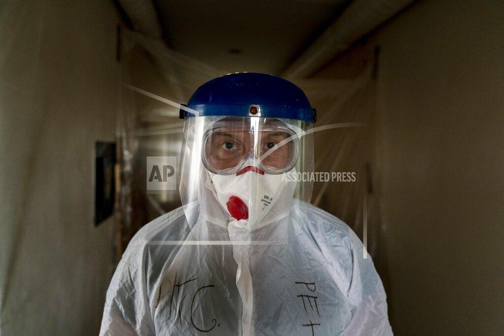 Evgeniy Maloletka Dr. Oleh Hornostayev walks through a corridor at the hospital in Stryi, Ukraine, on Tuesday, Sept. 29, 2020. Coronavirus infections in Ukraine began surging in late summer, and the ripples are hitting towns in the western part of the country. The government wants to avoid imposing a new lockdown, but officials acknowledge that the rising infections could make it necessary. (AP Photo/Evgeniy Maloletka)