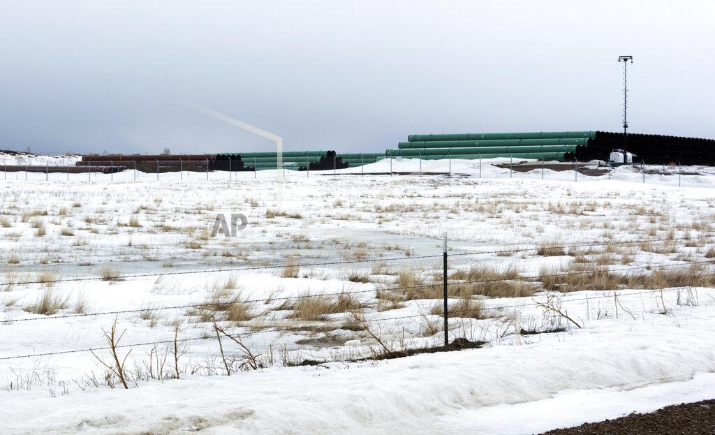 This March 11, 2020 photo provided by the Bureau of Land Management shows a storage yard north of Saco, Mont., for pipe that will be used in construction of the Keystone XL oil pipeline near the U.S.-Canada border. A Canadian company said Monday, April 6, 2020, that it's started construction on the long-stalled Keystone XL oil sands pipeline across the U.S.-Canada border, despite calls from tribal leaders and environmentalists to delay the $8 billion project amid the coronavirus pandemic. (Al Nash/Bureau of Land Management via AP)