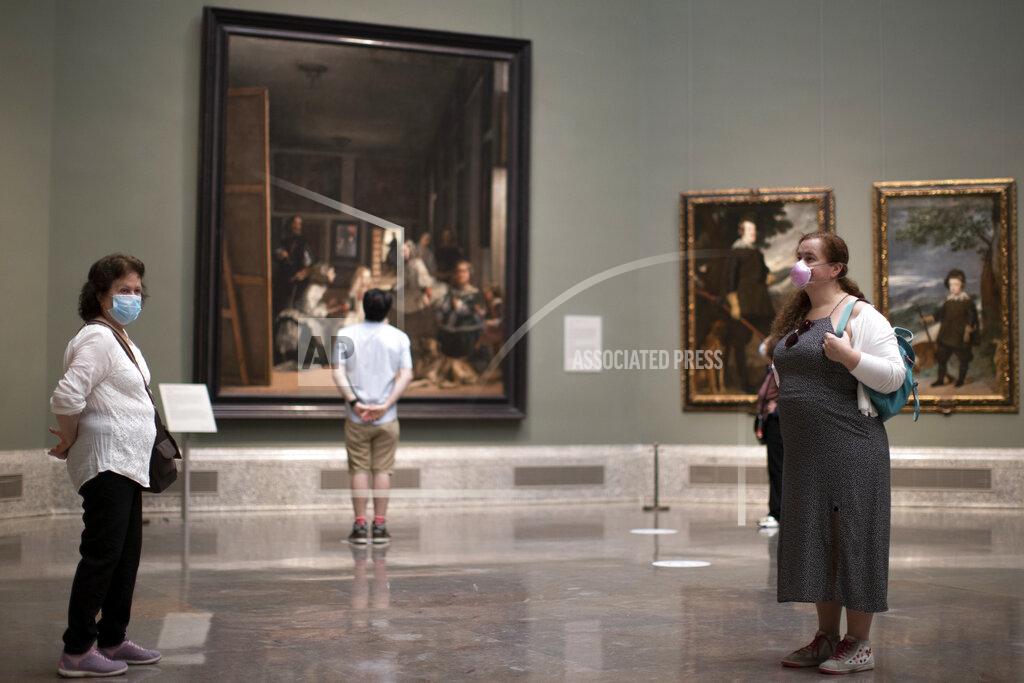 Manu Fernandez Visitors during the reopening of the Prado museum to the public in Madrid, Spain, Saturday, June 6, 2020. Madrid's Museo del Prado opened its doors on Saturday for 1,800 visitors, after its closing during the coronavirus pandemic. The visitors were required to wear face masks and have their temperature taken before taking in what the museum called its "most iconic works". (AP Photo/Manu Fernandez)
