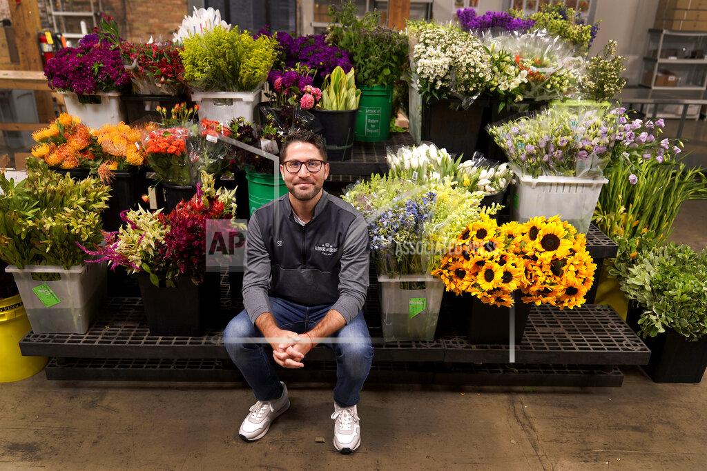 Charles Rex Arbogast Steven Dyme, owner of Flowers for Dreams, poses for a portrait at his warehouse Friday, July 23, 2021, in Chicago. Dyme says the $15 minimum made it much easier to staff up when the economy reopened this spring and demand for flowers, particularly for weddings, soared. The company has four locations, including its headquarters in Chicago, one in Milwaukee, and two in Detroit. (AP Photo/Charles Rex Arbogast)