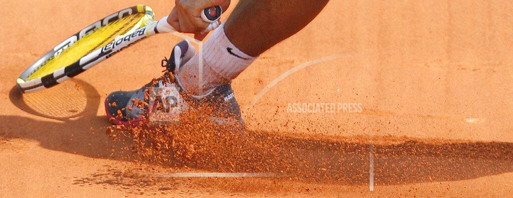 Christophe Ena FILE- In this Monday, May 25, 2009, image, Spain's Rafael Nadal slides in the clay as he returns the ball to Brazil's Marcos Daniel during a first round match at the Roland Garros stadium in Paris. Sliding is one of the keys to success at the French Open, with the ability to glide along the ground to reach shots that others can't, is one of the skills that makes Rafael Nadal so successful on clay courts, although the start of the French Open postponed until September because of the coronavirus. (AP Photo/Christophe Ena, File)