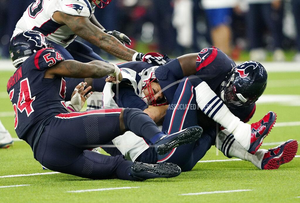 David J. Phillip New England Patriots quarterback Tom Brady, center, is sacked by Houston Texans linebacker Jake Martin (54) and defensive end Charles Omenihu (94) during the second half of an NFL football game Sunday, Dec. 1, 2019, in Houston. (AP Photo/David J. Phillip)