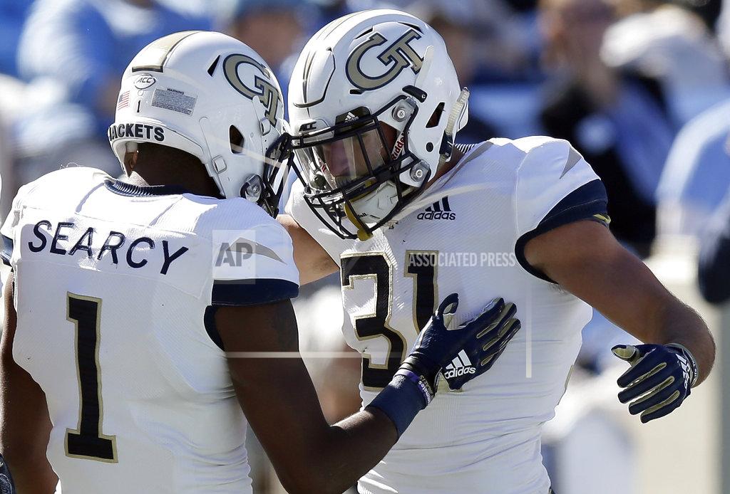 Gerry Broome Georgia Tech's Qua Searcy (1) congratulates Nathan Cottrell (31) following Cottrell's touchdown against North Carolina during the first half of an NCAA college football game in Chapel Hill, N.C., Saturday, Nov. 3, 2018. (AP Photo/Gerry Broome)