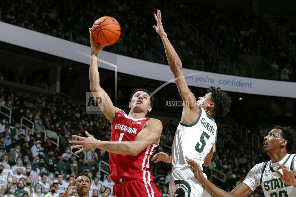 Al Goldis Wisconsin's Johnny Davis, left, shoots against Michigan State's Max Christie (5) during the first half of an NCAA college basketball game, Tuesday, Feb. 8, 2022, in East Lansing, Mich. (AP Photo/Al Goldis)