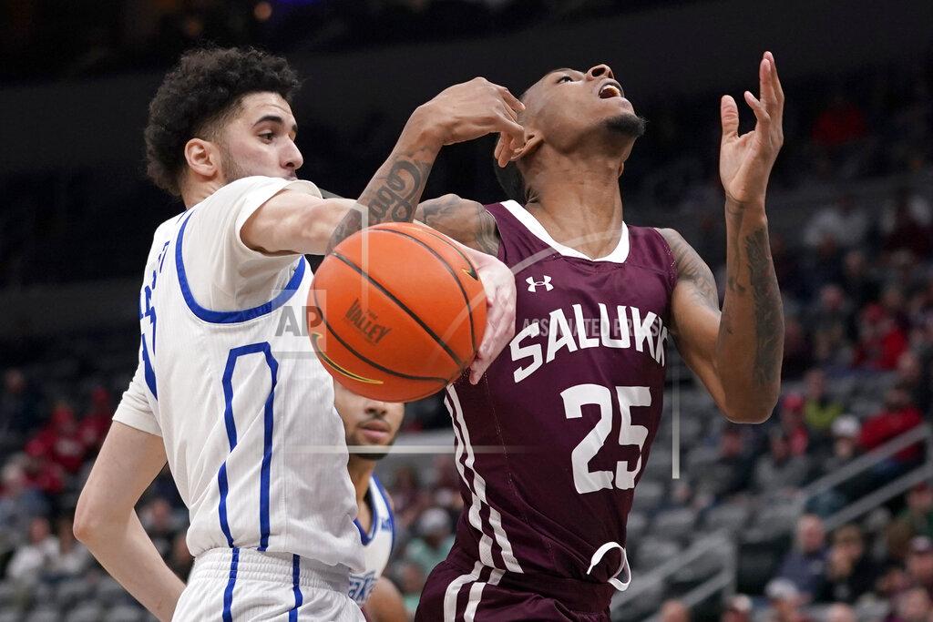Jeff Roberson Southern Illinois' Ben Coupet Jr. (25) is fouled on his way to the basket by Drake's Okay Djamgouz during the second half of an NCAA college basketball game in the quarterfinal round of the Missouri Valley Conference tournament Friday, March 4, 2022, in St. Louis. (AP Photo/Jeff Roberson)
