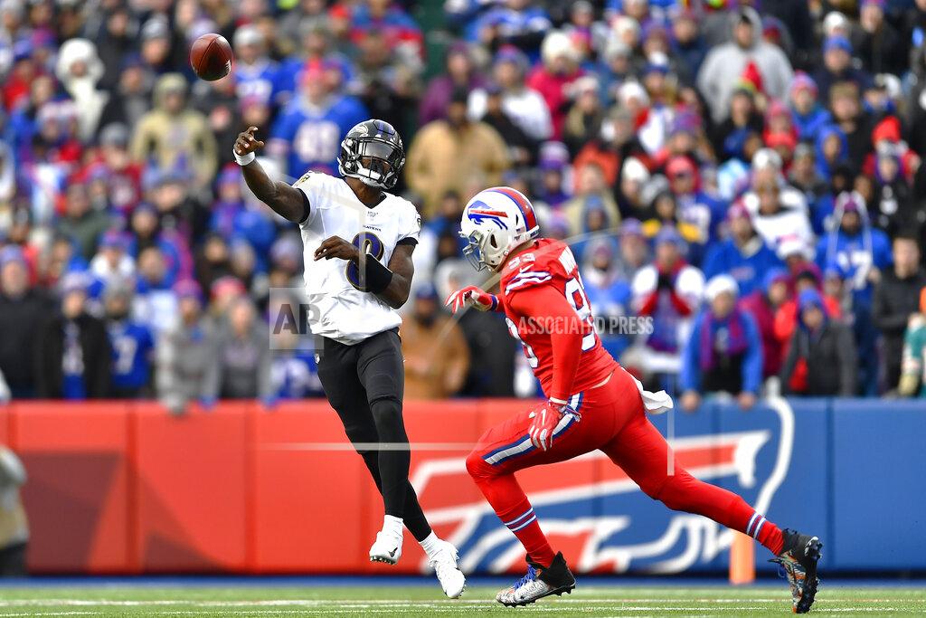 Adrian Kraus Baltimore Ravens quarterback Lamar Jackson (8) throws a pass under pressure by Buffalo Bills defensive end Trent Murphy (93) during the second half of an NFL football game in Orchard Park, N.Y., Sunday, Dec. 8, 2019. The Ravens won 24-17. (AP Photo/Adrian Kraus)