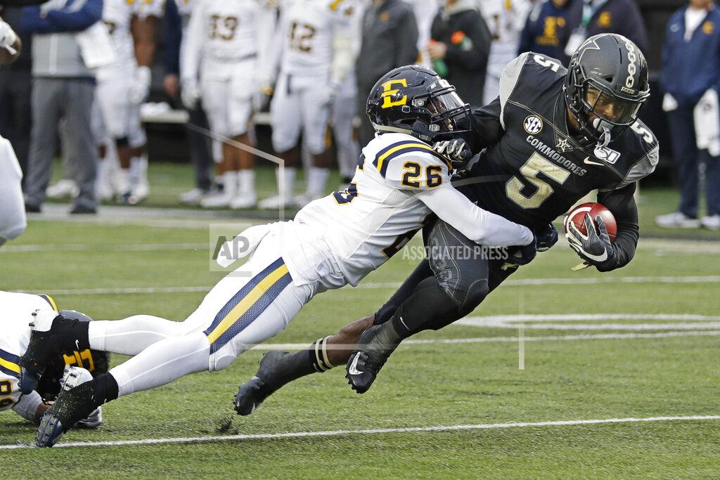 Mark Humphrey Vanderbilt running back Ke'Shawn Vaughn (5) is stopped by ETSU defensive back Artevius Smith (26) in the first half of an NCAA college football game Saturday, Nov. 23, 2019, in Nashville, Tenn. (AP Photo/Mark Humphrey)