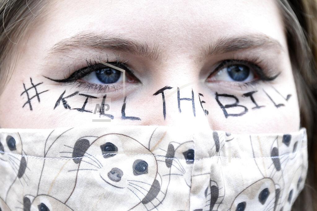 Alberto Pezzali A demonstrator wears a face mask and a slogan painted on her face during a 'Kill the Bill' protest in London, Saturday, April 3, 2021. The demonstration is against the contentious Police, Crime, Sentencing and Courts Bill, which is currently going through Parliament and would give police stronger powers to restrict protests. (AP Photo/Alberto Pezzali)