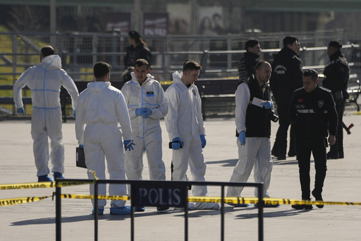 Security officers check the site where two attackers were killed outside a courthouse in Istanbul, Turkey, Tuesday, Feb. 6, 2024. Two people were shot dead while trying to attack a courthouse in Istanbul on Tuesday, Turkish Interior Minister Ali Yerlikaya said. (AP Photo/Francisco Seco)