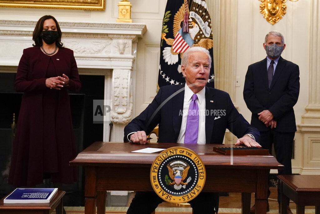 Alex Brandon FILE - In this Jan. 21, 2021, file photo, President Joe Biden reacts to a reporters question after signing executive orders in the State Dinning Room of the White House, in Washington. Vice President Kamala Harris, left, and Dr. Anthony Fauci, director of the National Institute of Allergy and Infectious Diseases, right, look on. (AP Photo/Alex Brandon, File)