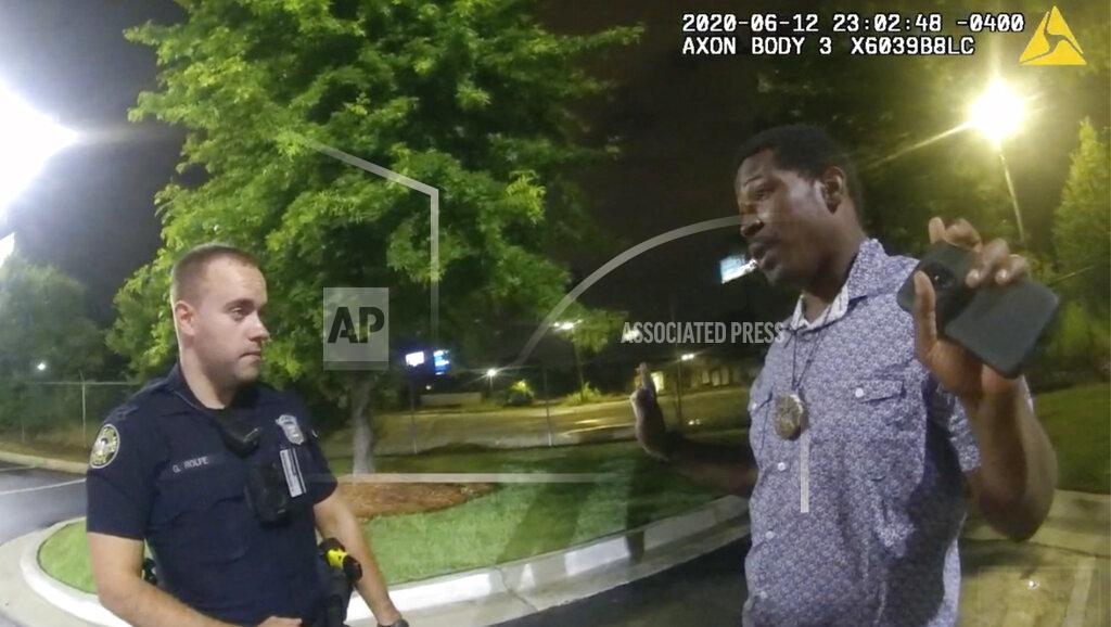 Uncredited FILE - This screen grab taken from body camera video provided by the Atlanta Police Department shows Rayshard Brooks speaking with Officer Garrett Rolfe, left, in the parking lot of a Wendy's restaurant, late Friday, June 12, 2020, in Atlanta. Rolfe, who fatally shot Rayshard Brooks in the back after the fleeing man pointed a stun gun in his direction, was charged with felony murder and 10 other charges, announced Wednesday, June 17, 2020. Rolfe was fired after the shooting. (Atlanta Police Department via AP)