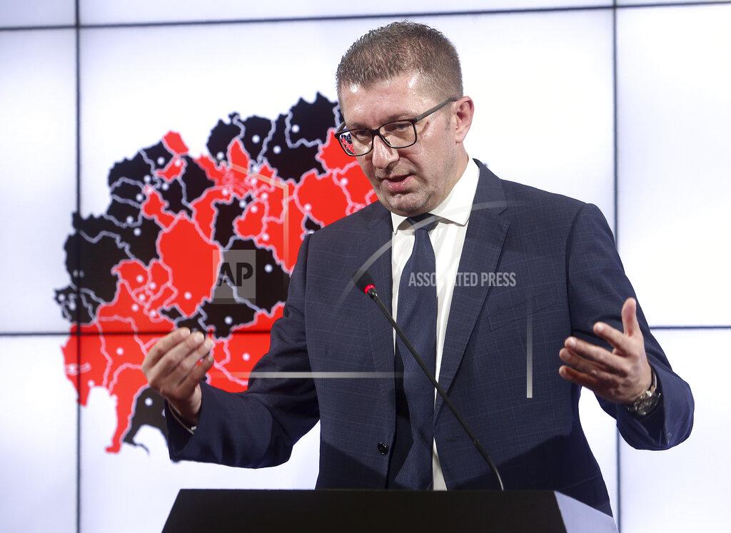 Boris Grdanoski Hristijan Mickoski, the leader of the opposition VMRO DPMNE party talks to the media in party headquarters in Skopje, North Macedonia on Thursday, July 16, 2020, a day after the country's parliamentary elections. The pro-Western, ruling SDSM party in North Macedonia is poised to try to form a coalition government following a narrow election victory. (AP Photo/Boris Grdanoski)