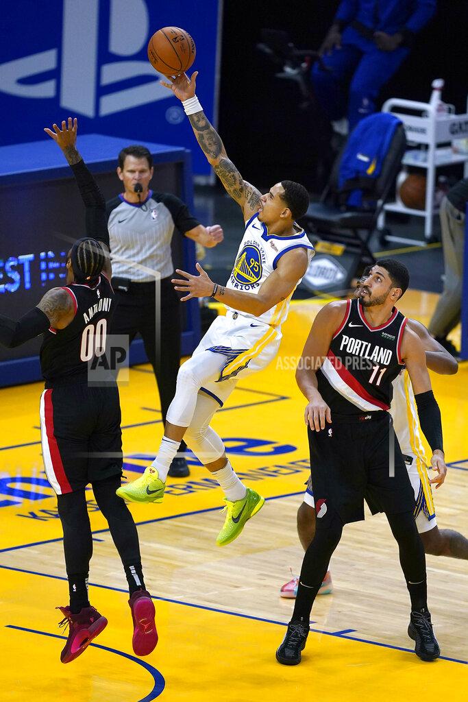 Tony Avelar Golden State Warriors forward Juan Toscano-Anderson (95) drives to the basket against Portland Trail Blazers' Carmelo Anthony (00) and Enes Kanter (11) during the first half of an NBA basketball game in San Francisco, Friday, Jan. 1, 2021. (AP Photo/Tony Avelar)