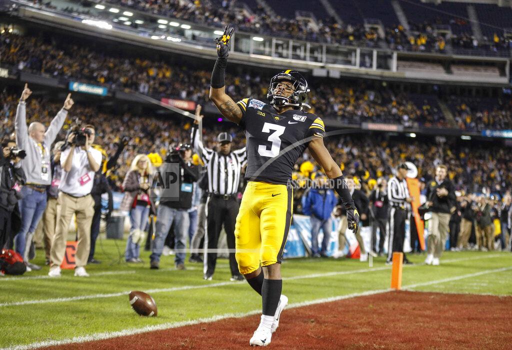 Bryon Houlgrave/The Register FILE - In this Dec. 27, 2019, file photo, Iowa freshman running back Tyrone Tracy Jr., runs the ball for a touchdown against USC in the first quarter during the Holiday Bowl NCAA college football game in San Diego. Big Ten is going to give fall football a shot after all. Less than five weeks after pushing football and other fall sports to spring in the name of player safety during the pandemic, the conference changed course Wednesday, Sept. 16, 2020, and said it plans to begin its season the weekend of Oct. 23-24. (Bryon Houlgrave/The Des Moines Register via AP, File)