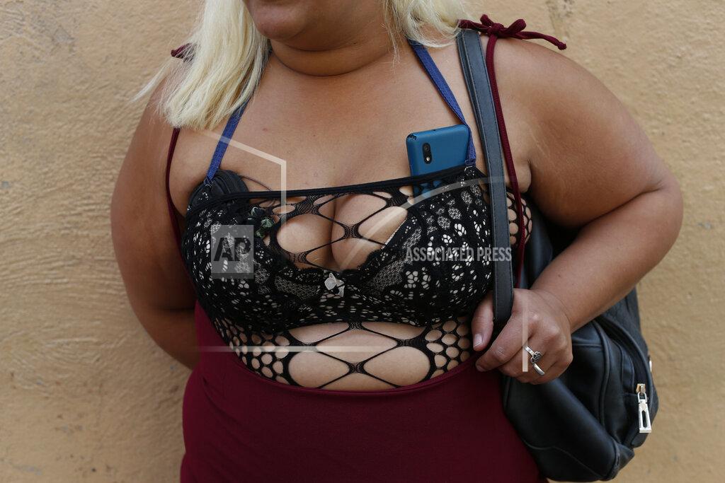 Rebecca Blackwell A sex worker waits for clients on a street corner in central Mexico City, Saturday, March 6, 2021. Hardships caused by the coronavirus pandemic have forced former sex workers in Mexico back into the trade years after they left, made it more dangerous and reduced some to having sex in cars or on sidewalks for lack of available hotels. (AP Photo/Rebecca Blackwell)