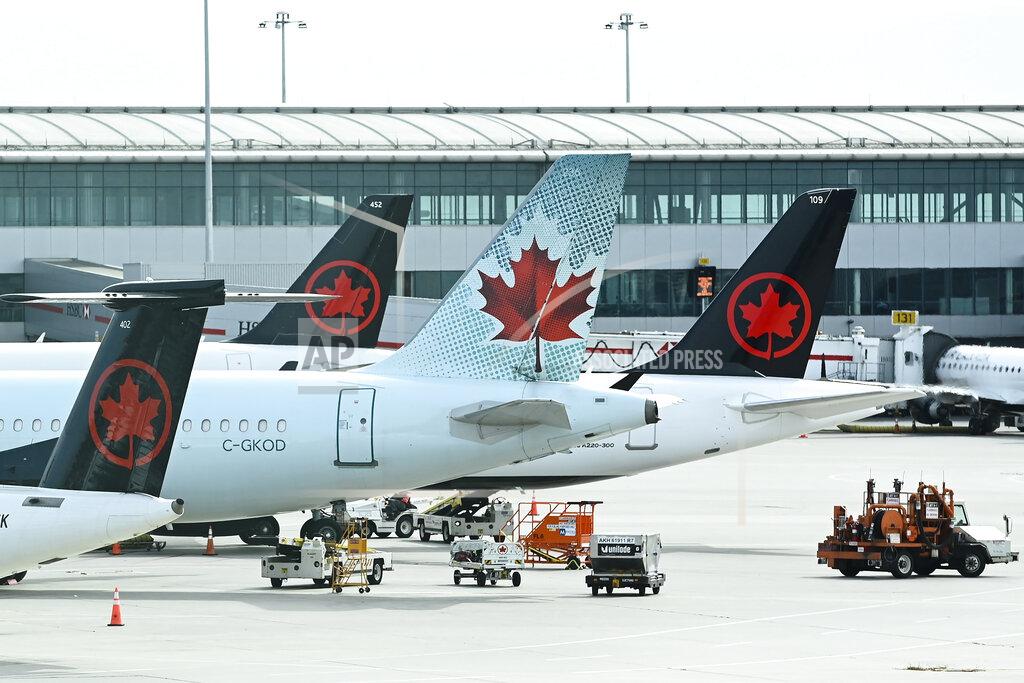 Nathan Denette FILE - In this Wednesday, Oct. 14, 2020 file photo, Air Canada planes sit on the tarmac at Pearson International airport during the COVID-19 pandemic in Toronto. On Friday, July 23, 2021, The Associated Press reported on stories circulating online incorrectly asserting Canada prohibits vaccinated pilots from flying. But Canada’s transportation agency allows pilots to receive any vaccine that’s been approved by the country’s health regulator, Health Canada, according to Transport Canada Senior Communications Adviser Sau Sau Liu. (Nathan Denette/The Canadian Press via AP, File)
