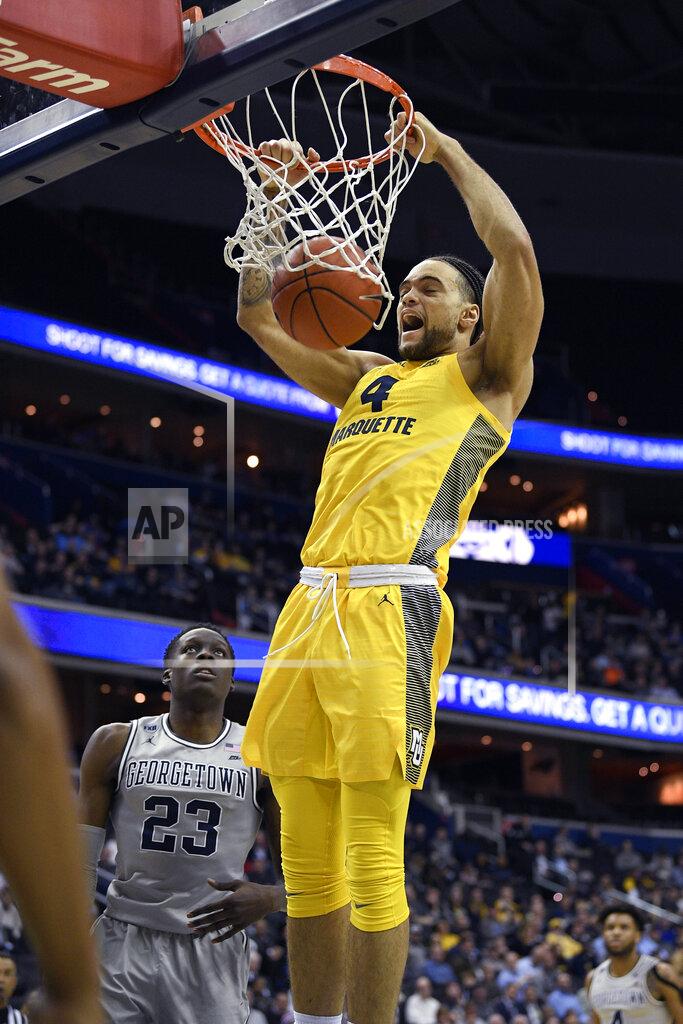 Nick Wass Marquette forward Theo John (4) dunks against Georgetown forward Josh LeBlanc (23) during the first half of an NCAA college basketball game, Tuesday, Jan. 15, 2019, in Washington. (AP Photo/Nick Wass)