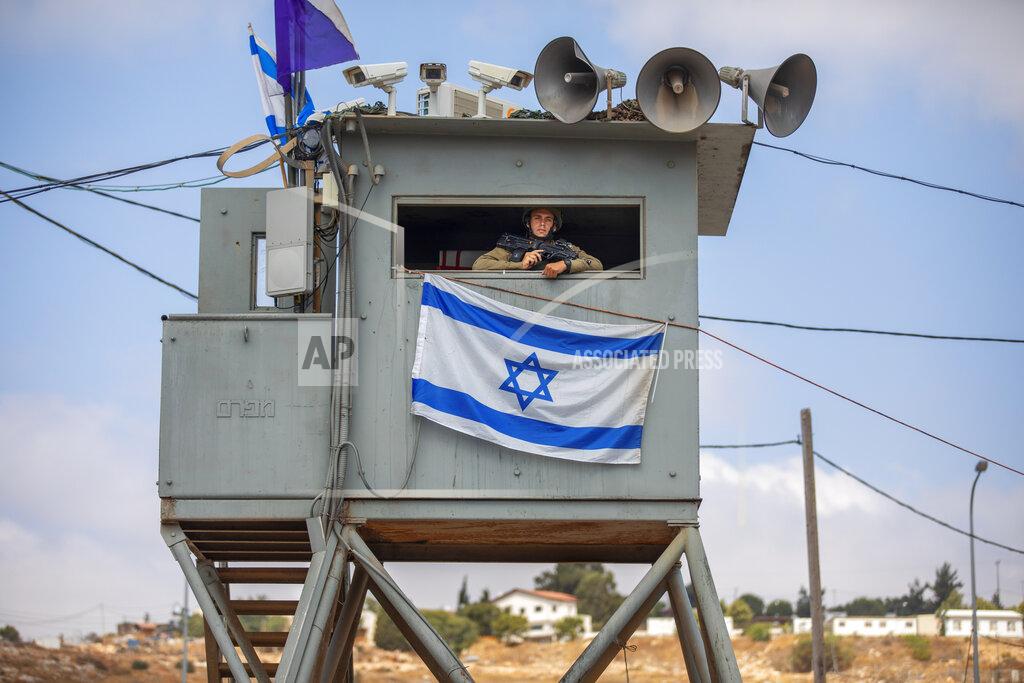 Oded Balilty An Israeli soldier stands guard at the Tapuach junction next to the West Bank city of Nablus, Tuesday, June 30, 2020. Israeli Prime Minister Benjamin Netanyahu appears determined to carry out his pledge to begin annexing parts of the occupied West Bank, possibly as soon as Wednesday. (AP Photo/Oded Balilty)