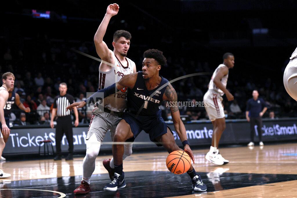 Adam Hunger Xavier's Paul Scruggs (1) drives past Virginia Tech's Hunter Cattoor during the first half of an NCAA college basketball game in the NIT Season Tip-Off tournament Friday, Nov. 26, 2021, in New York. (AP Photo/Adam Hunger)