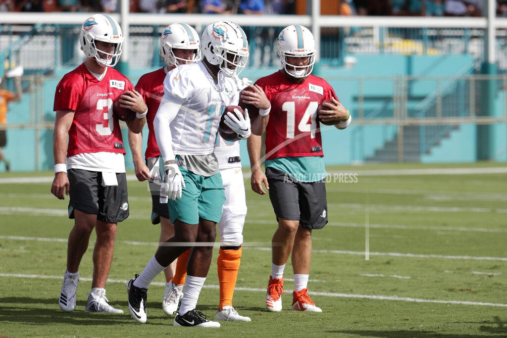 Lynne Sladky Miami Dolphins quarterback Josh Rosen (3), wide receiver DeVante Parker (11) and quarterback Ryan Fitzpatrick (14) run drills during NFL football training camp, Thursday, July 25, 2019, in Davie, Fla. (AP Photo/Lynne Sladky)