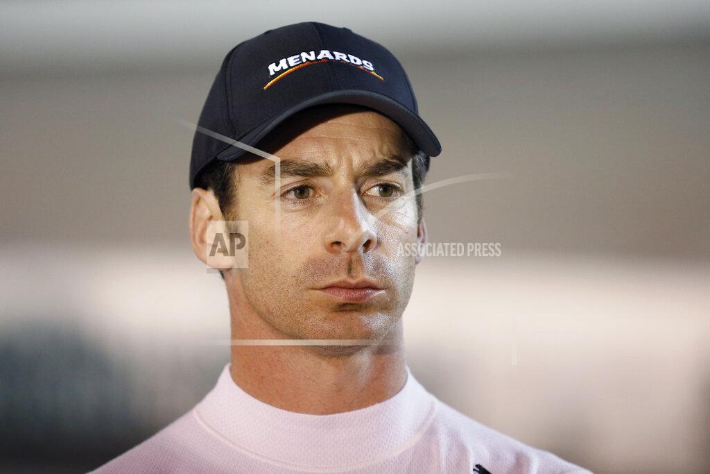 Charlie Neibergall File- This July 20, 2019, file photo shows Simon Pagenaud waiting by his car before an IndyCar Series auto race , at Iowa Speedway in Newton, Iowa. Josef Newgarden has been the IndyCar points leader for all but one race this season and built enough of a cushion that his mindset has changed as the championship race speeds into an anticlimactic final two events of the year. Newgarden leads Team Penske teammate and Indianapolis 500 winner Simon Pagenaud by 38 points. (AP Photo/Charlie Neibergall, File)
