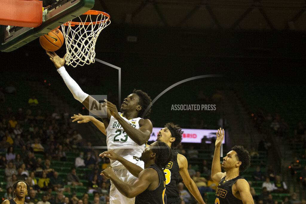Emil Lippe Baylor forward Jonathan Tchamwa Tchatchoua (23) goes up for a layup in the first half of an NCAA college basketball game against Arkansas Pine Bluff in Waco, Texas, Saturday, Dec. 4, 2021. (AP Photo/Emil Lippe)