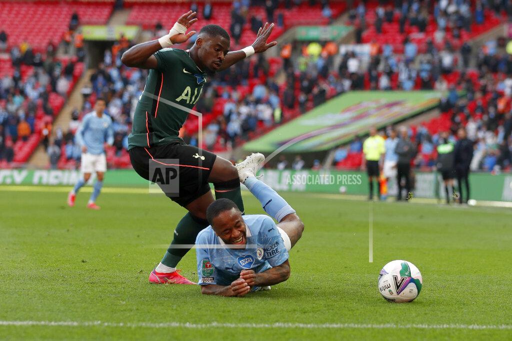 Alastair Grant Tottenham's Serge Aurier fouls Manchester City's Raheem Sterling, on the ground, during the English League Cup final soccer match between Manchester City and Tottenham Hotspur at Wembley stadium in London, Sunday, April 25, 2021. (AP Photo/Alastair Grant)