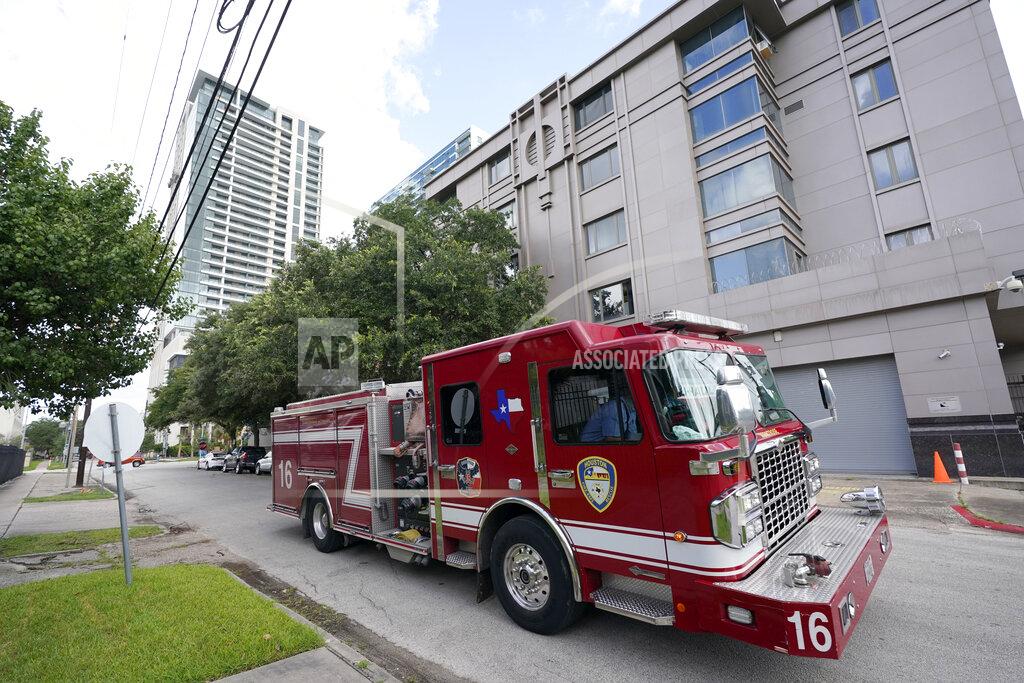 David J. Phillip A Houston firetruck drives past the Chinese Consulate Thursday, July 23, 2020, in Houston. China says “malicious slander" is behind an order by the U.S. government to close its consulate in Houston, and maintains that its officials have never operated outside ordinary diplomatic norms. (AP Photo/David J. Phillip)