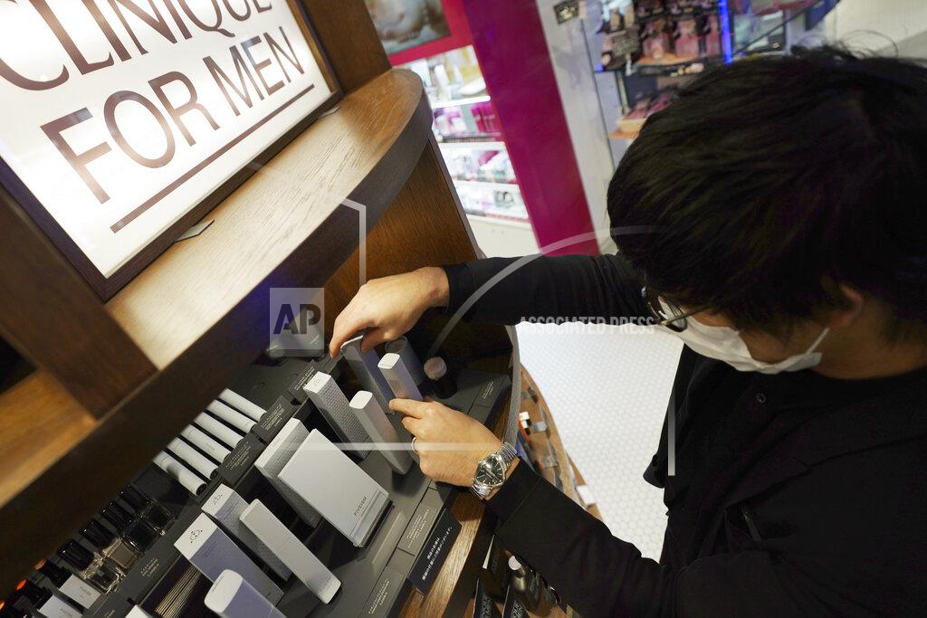 Eugene Hoshiko A shop staff arranges beauty products for men at @cosme TOKYO, a store selling a selection of cosmetics and makeup products including men's cosmetic, in Tokyo's Harajuku district Tuesday, Feb. 9, 2021. The coronavirus pandemic has been pushing businesses to the edge in Japan, but some in the men's beauty industry have seen an unexpected expansion in their customer base. Japanese businessmen in their 40s, 50s and 60s who had little interest in cosmetics before the pandemic are now buying makeup. (AP Photo/Eugene Hoshiko)