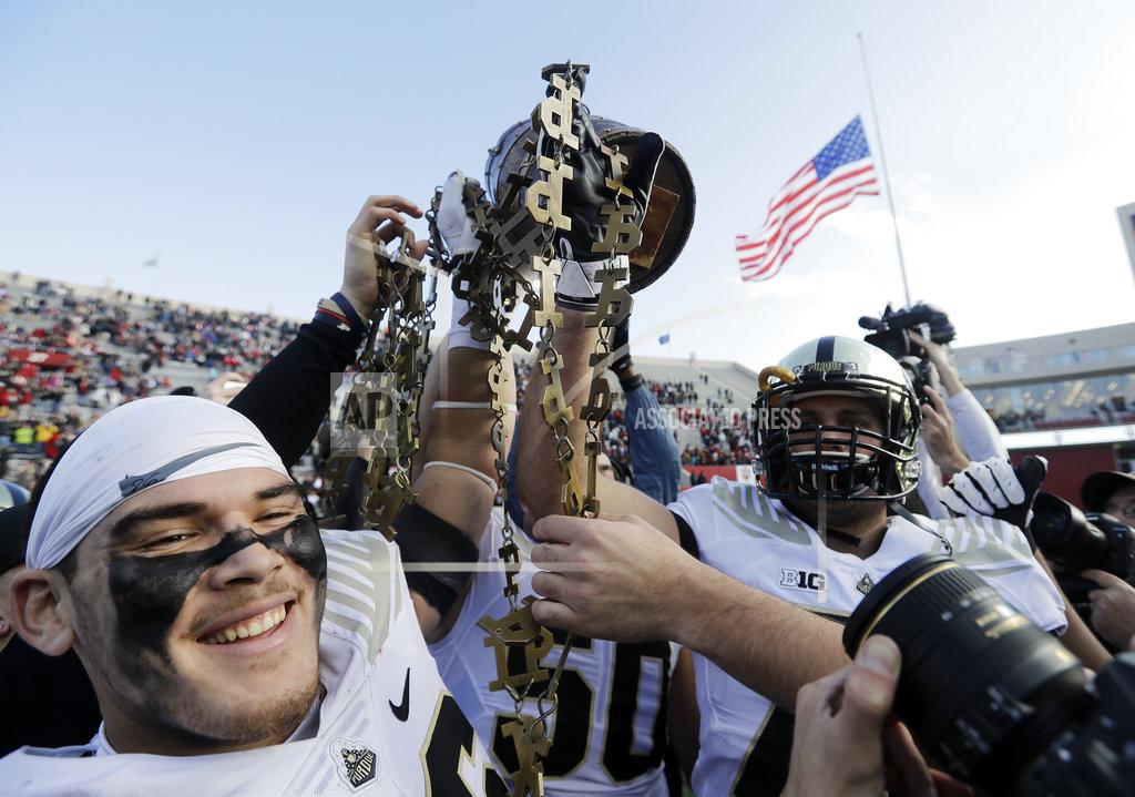 Darron Cummings Purdue's Ray Ellis, left, holds the Old Oaken Bucket with his teammates after Purdue defeated Indiana, 28-21, in an NCAA college football game, Saturday, Nov. 24, 2018, in Bloomington, Ind. (AP Photo/Darron Cummings)