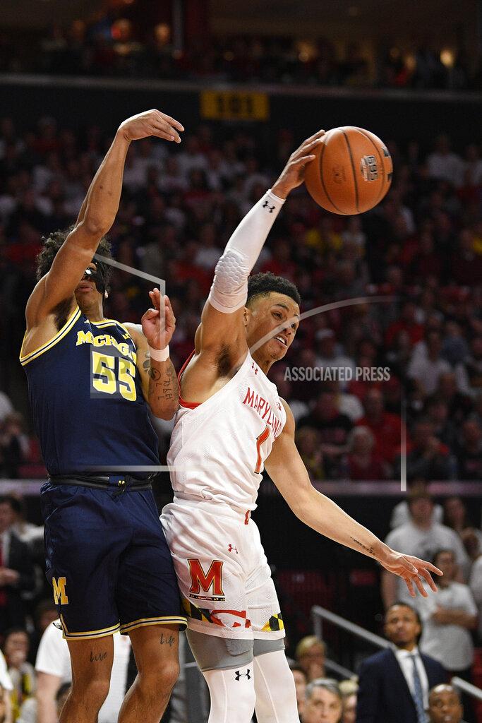 Nick Wass Maryland guard Anthony Cowan Jr. (1) grabs the ball away next to Michigan guard Eli Brooks (55) during the first half of an NCAA college basketball game, Sunday, March 8, 2020, in College Park, Md. (AP Photo/Nick Wass)