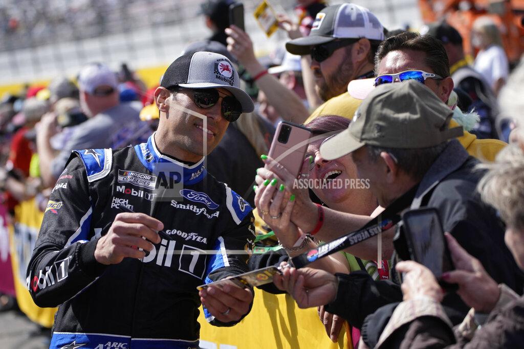 John Locher Aric Almirola poses for pictures before a NASCAR Cup Series auto race Sunday, March 6, 2022, in Las Vegas. (AP Photo/John Locher)