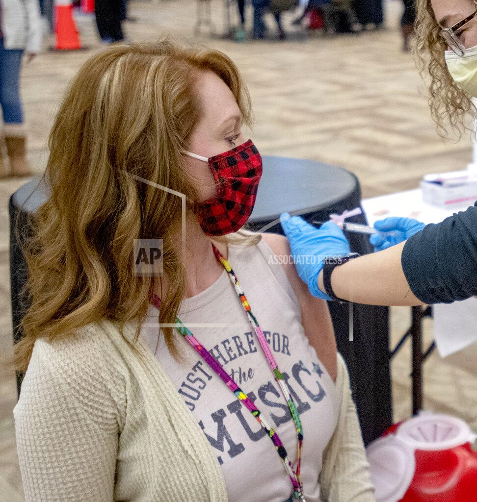 David Crigger Sara Kate Tallman, who teaches at Van Pelt and Highland View Elementary Schools in Bristol Virginia, gets her COVID-19 vaccine on Monday afternoon. Teachers from Bristol Virginia and Washington County Virginia received their first vaccine during an all-day event at the Virginia Highlands Higher Education Center in Abingdon, Virginia. (David Crigger/Bristol Herald Courier via AP)